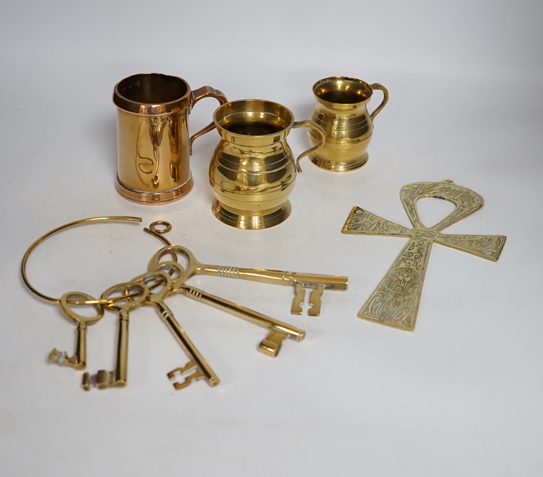 A Bells scotch whiskey table bell and Johnnie Walker copper advertising dish, old keys, graduated tankards, 18th/19th century copper milk skimmer, a cornet, etc. (13)